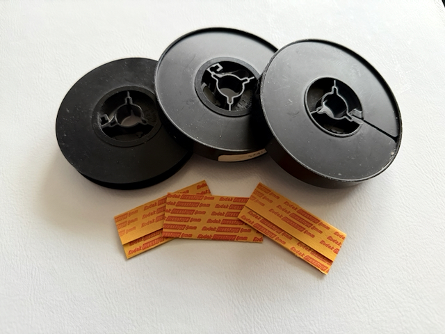 Three 50' reels of cine film and some splices